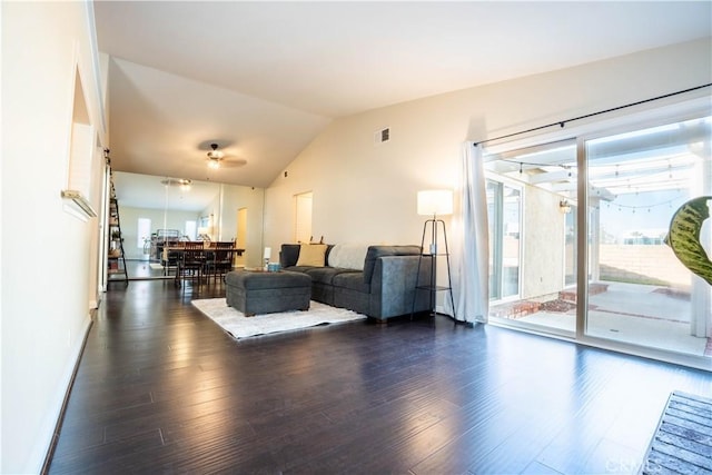 living room featuring ceiling fan, dark hardwood / wood-style flooring, and vaulted ceiling