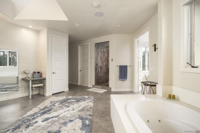 bathroom with plenty of natural light and independent shower and bath