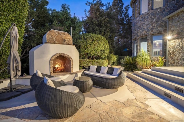 view of patio with an outdoor stone fireplace