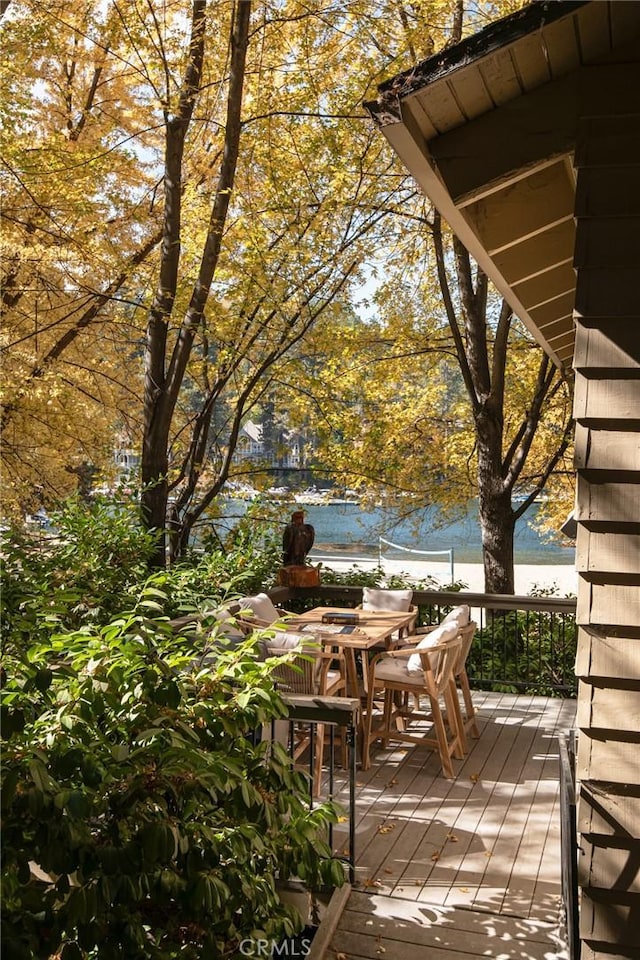 view of patio featuring a deck with water view