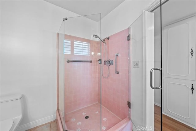 bathroom with toilet and walk in shower