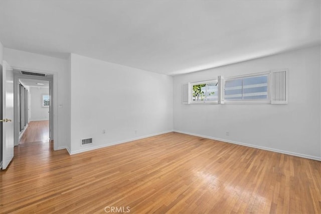 empty room with light hardwood / wood-style floors