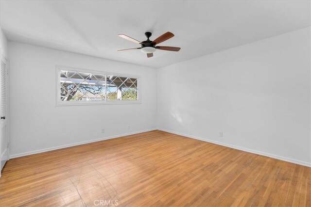 spare room with ceiling fan and light hardwood / wood-style flooring