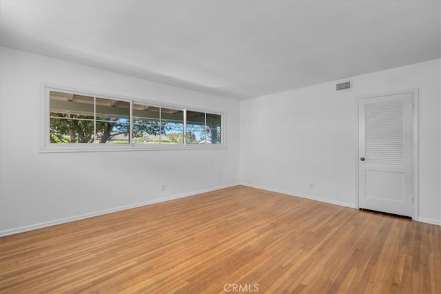 empty room with light hardwood / wood-style floors