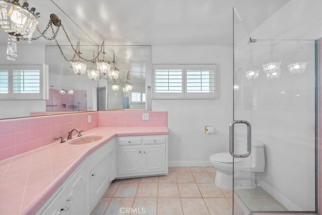 bathroom with a healthy amount of sunlight, tile patterned floors, backsplash, and toilet