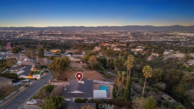 aerial view at dusk featuring a mountain view