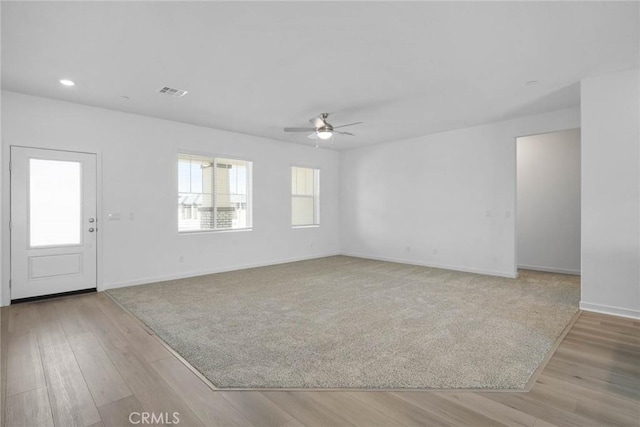 unfurnished room with ceiling fan and light hardwood / wood-style floors