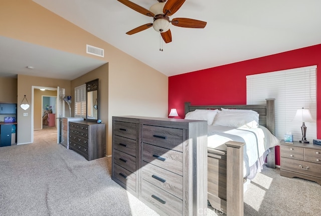 bedroom featuring lofted ceiling, light carpet, and ceiling fan