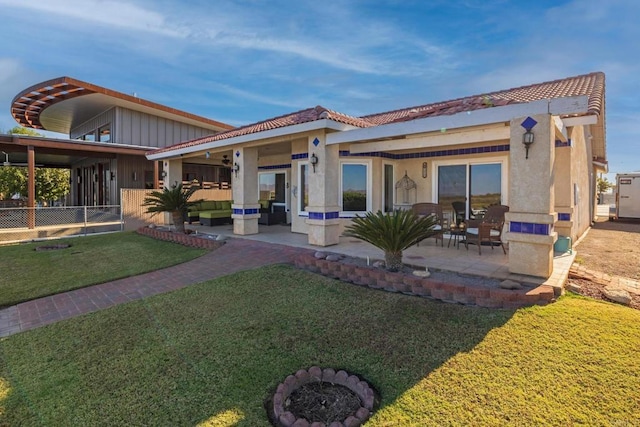 back of property featuring a patio and a lawn