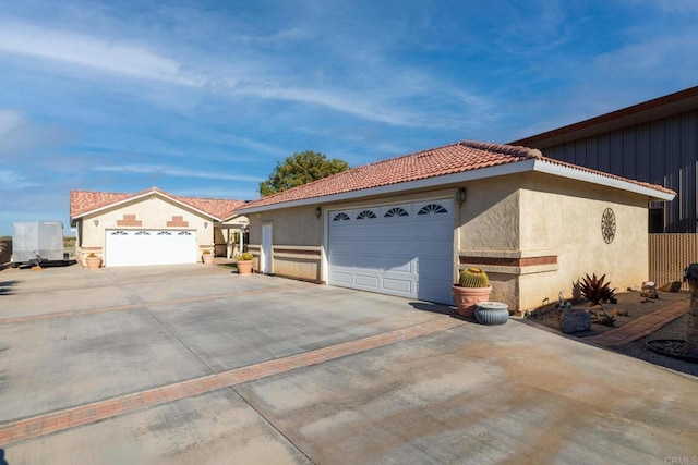 5770 Colorado River Rd, Blythe, CA 92225 - view of side of home with concrete driveway, stucco siding, and a garage