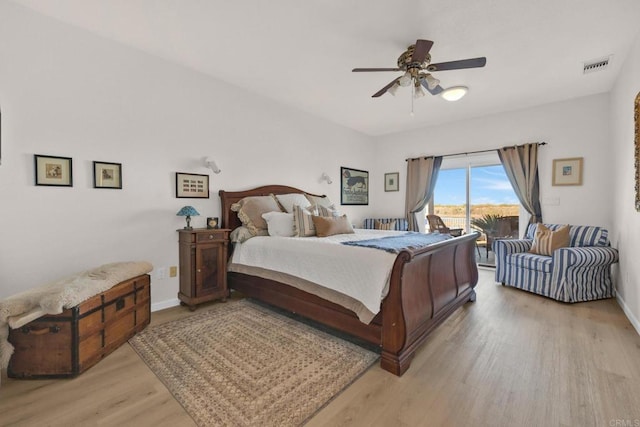 bedroom featuring access to exterior, ceiling fan, and light wood-type flooring