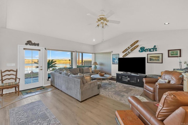 living room featuring french doors, light hardwood / wood-style flooring, ceiling fan, and lofted ceiling