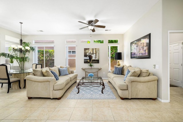 living room with light tile patterned floors and ceiling fan with notable chandelier