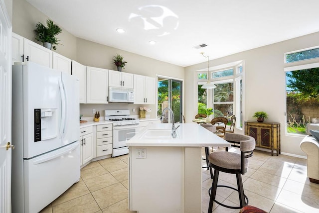 kitchen featuring light tile patterned floors, white appliances, white cabinetry, and hanging light fixtures