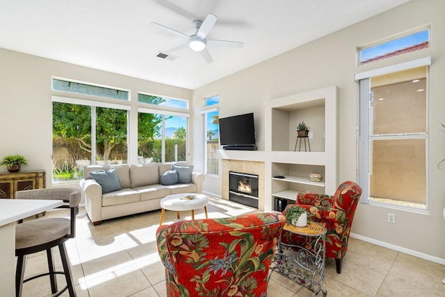 tiled living room with ceiling fan