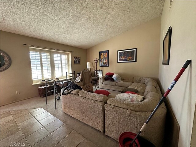 living room with a textured ceiling, lofted ceiling, and light tile patterned flooring