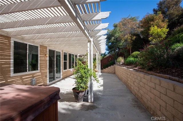 view of patio / terrace with a pergola and a hot tub