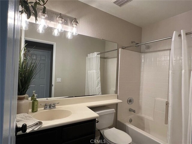 full bathroom with shower / tub combo, vanity, and toilet