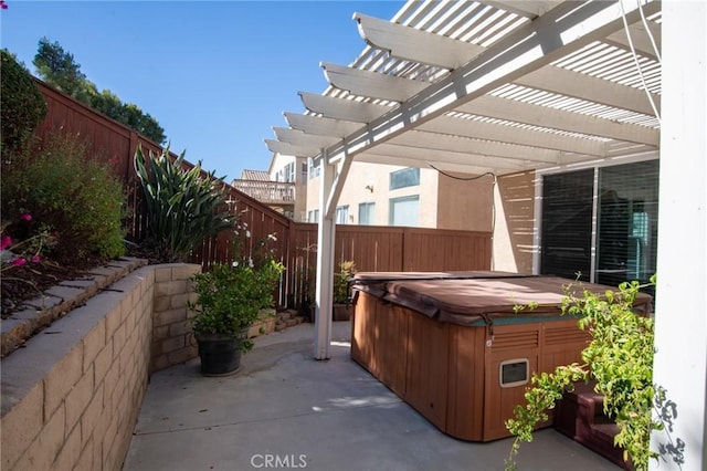 view of patio with a pergola and a hot tub