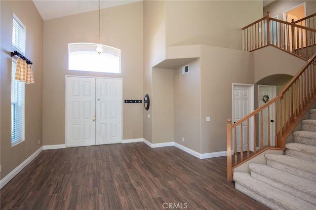 entrance foyer featuring dark hardwood / wood-style floors and high vaulted ceiling