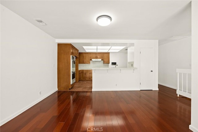 unfurnished living room with dark hardwood / wood-style flooring