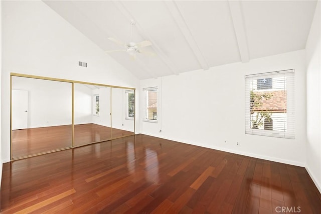 empty room featuring ceiling fan, hardwood / wood-style floors, high vaulted ceiling, and beamed ceiling