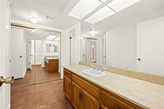 bathroom featuring tile patterned flooring and vanity