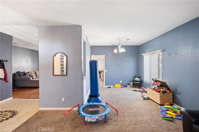 rec room with light tile patterned floors and a notable chandelier