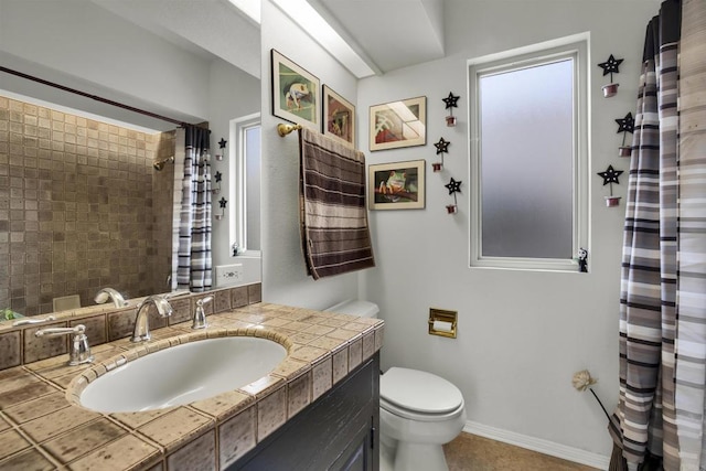 bathroom featuring tile patterned floors, vanity, and toilet