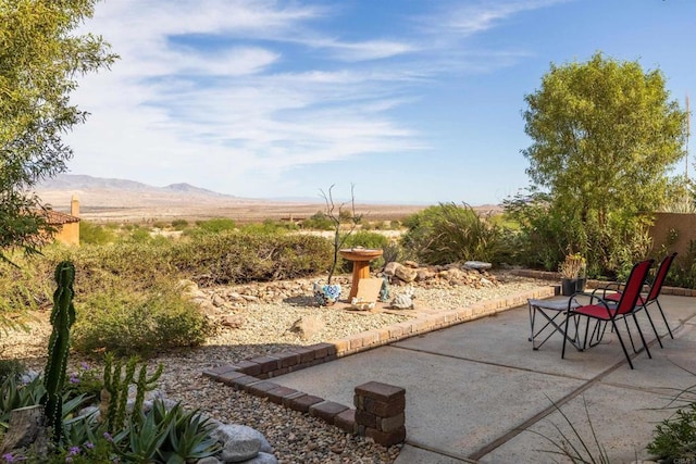 view of patio / terrace featuring a mountain view