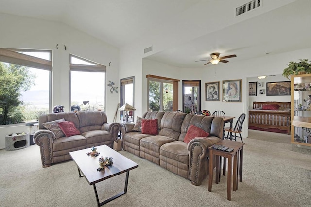 living room with ceiling fan, light colored carpet, and lofted ceiling