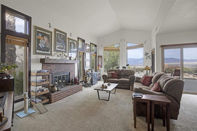 carpeted living room with a mountain view, vaulted ceiling, and a fireplace