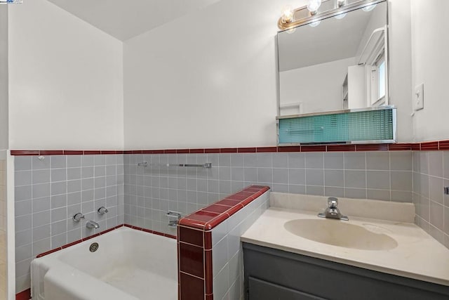 bathroom featuring a washtub, vanity, and tile walls