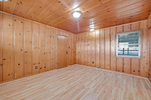 unfurnished room with wooden ceiling, light hardwood / wood-style floors, and wooden walls