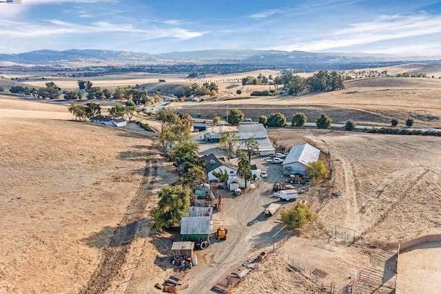 drone / aerial view featuring a mountain view and a rural view