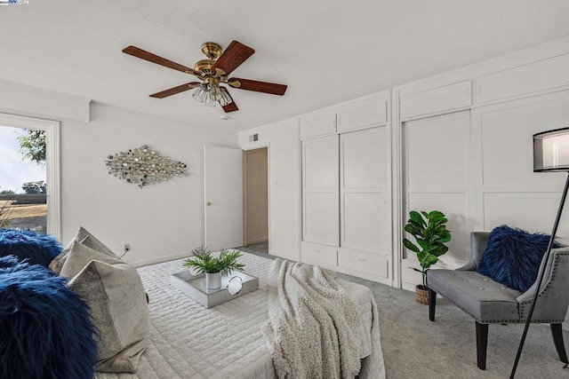 bedroom featuring light colored carpet and ceiling fan