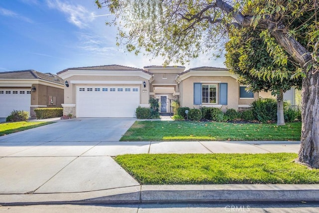 view of front of home featuring a garage and a front lawn