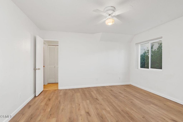 empty room with ceiling fan and light hardwood / wood-style floors