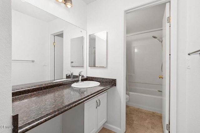 full bathroom featuring washtub / shower combination, vanity, toilet, and tile patterned flooring