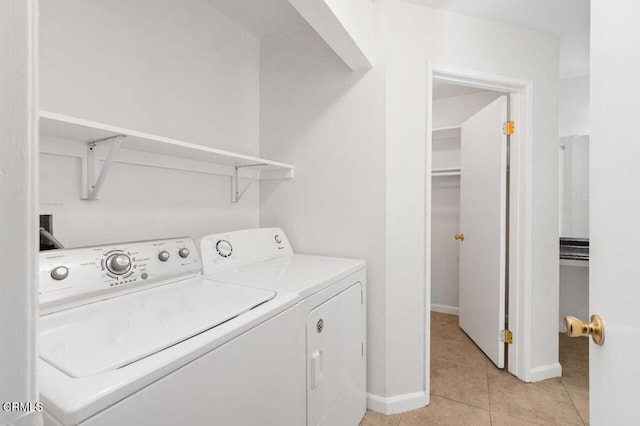 washroom featuring washer and dryer and light tile patterned flooring