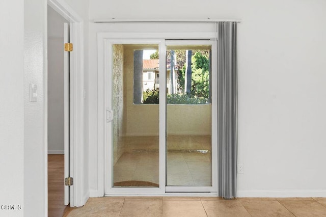 doorway to outside featuring light tile patterned floors