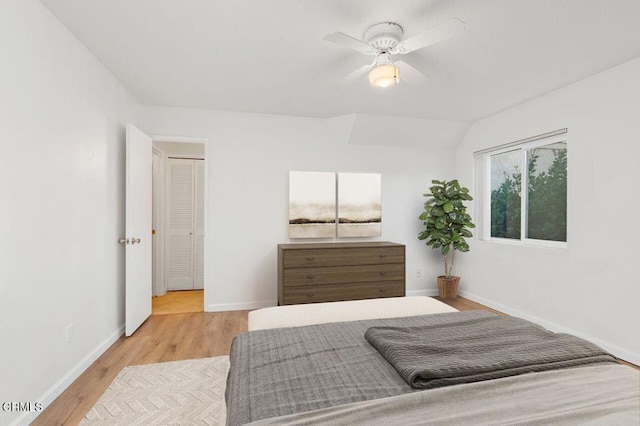 bedroom with vaulted ceiling, light hardwood / wood-style flooring, and ceiling fan