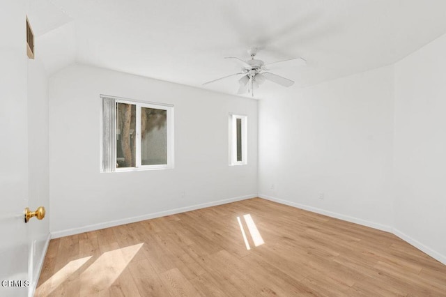 empty room with ceiling fan and light hardwood / wood-style floors