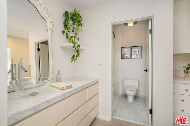 bathroom featuring vanity and toilet