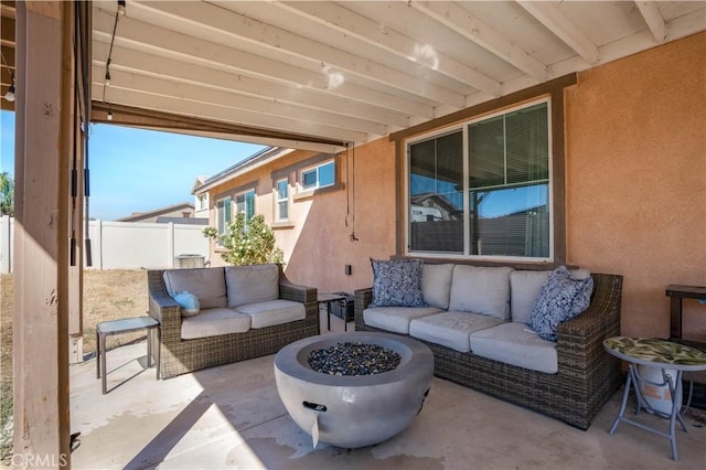 view of patio with an outdoor living space with a fire pit