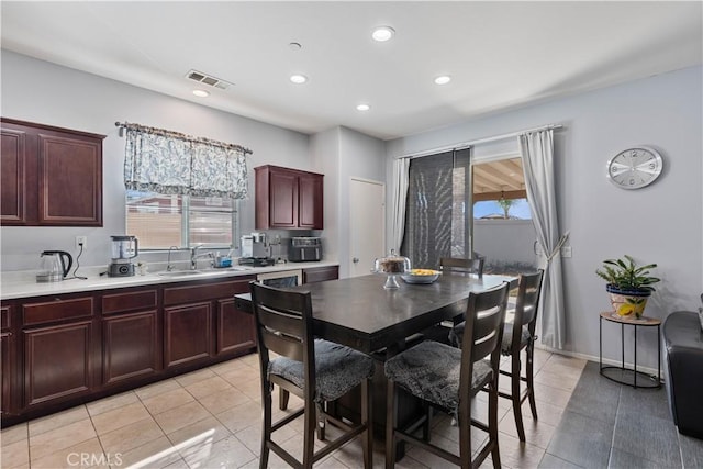 dining room with sink and light tile patterned floors