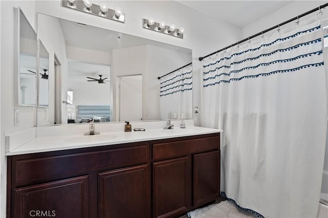 bathroom with a shower with curtain, ceiling fan, and vanity