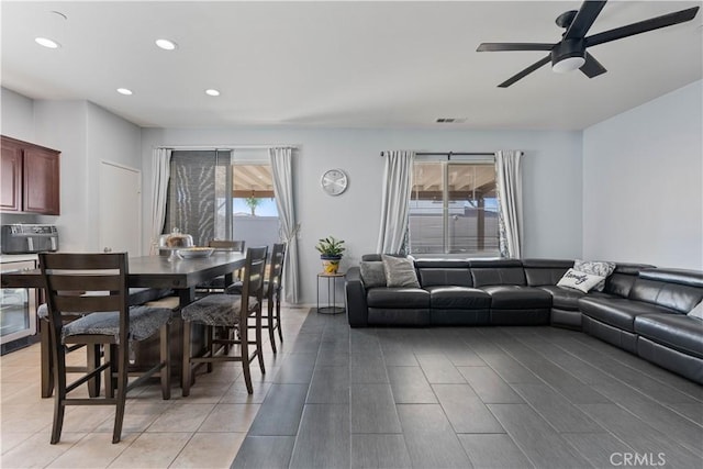 living room with ceiling fan and beverage cooler