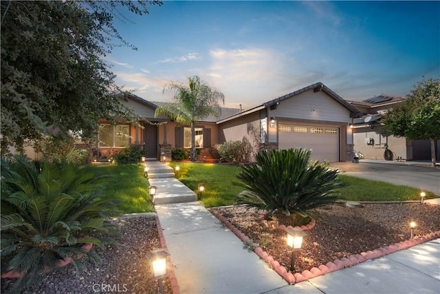 view of front of property featuring a lawn and a garage