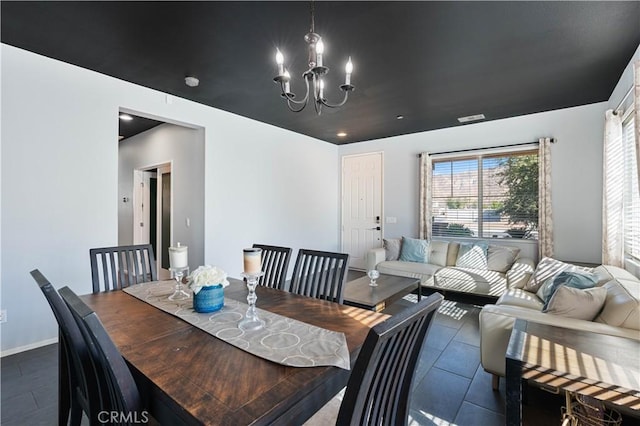 tiled dining area with a notable chandelier